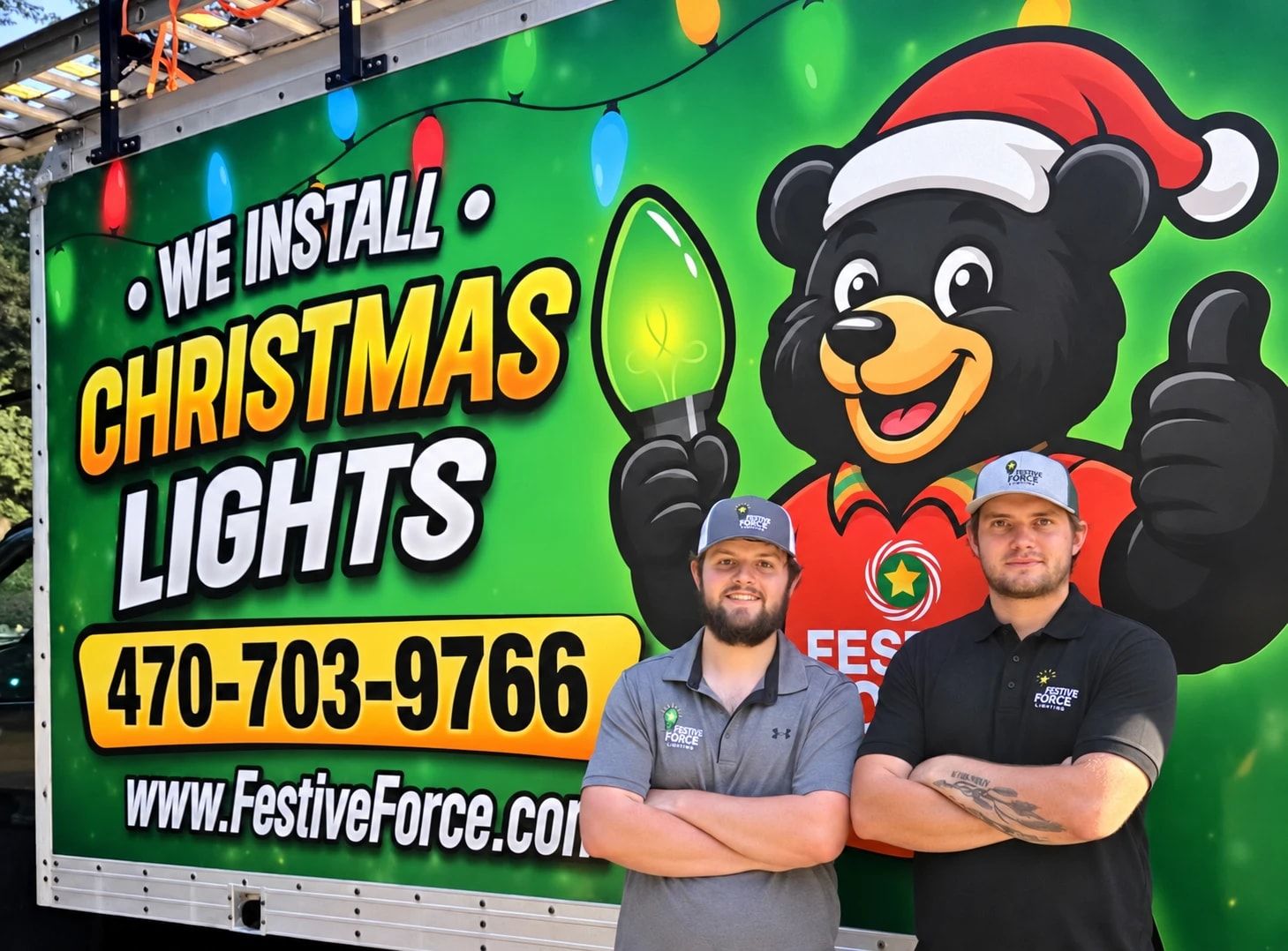 Dylan Rice and Logan Bogue of Festive Force Lighting standing in front of the Festive Force Christmas lights truck